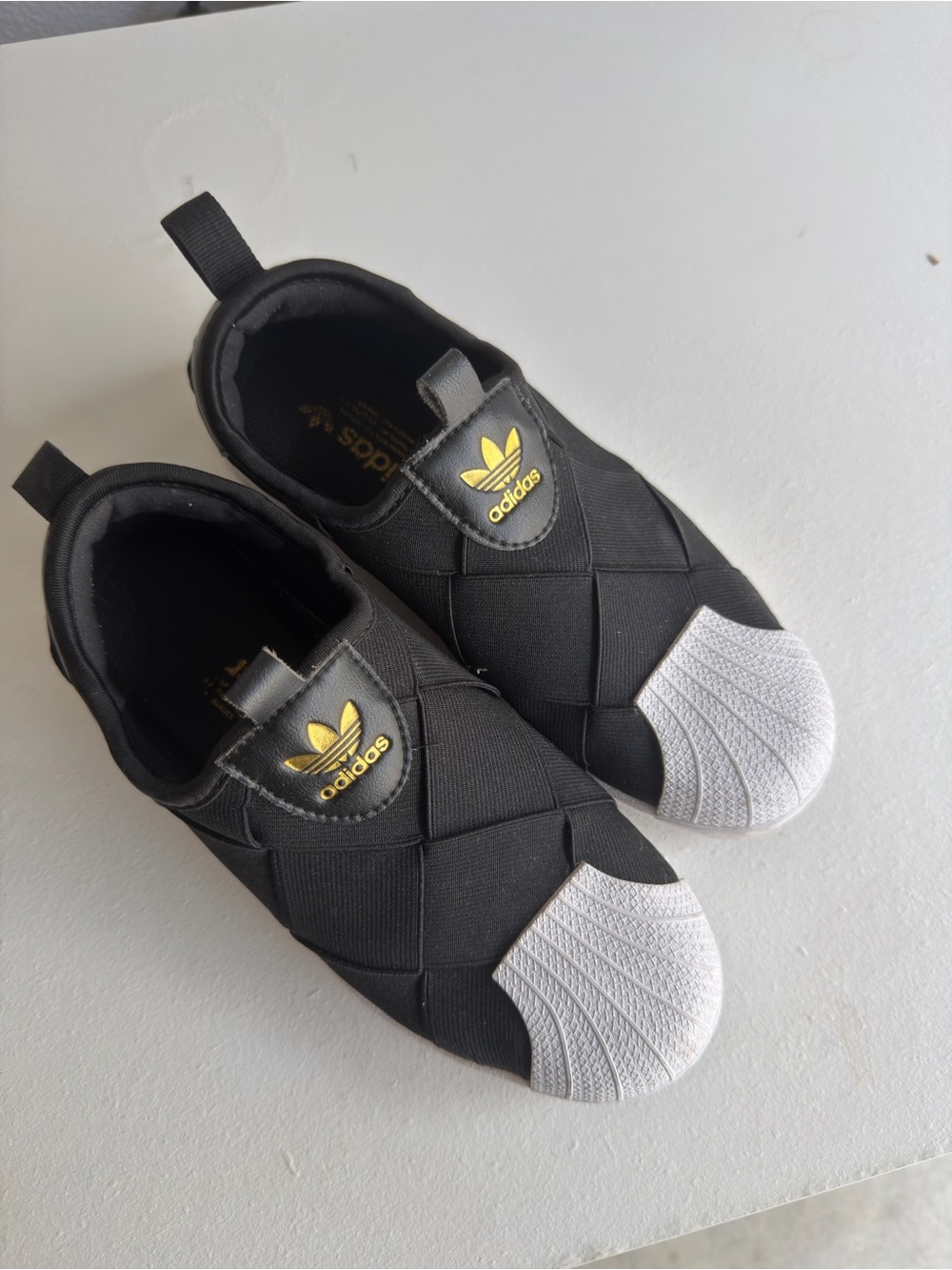 adidas Women Black Slip-On Sneakers with White Shell Toe and Gold Logo